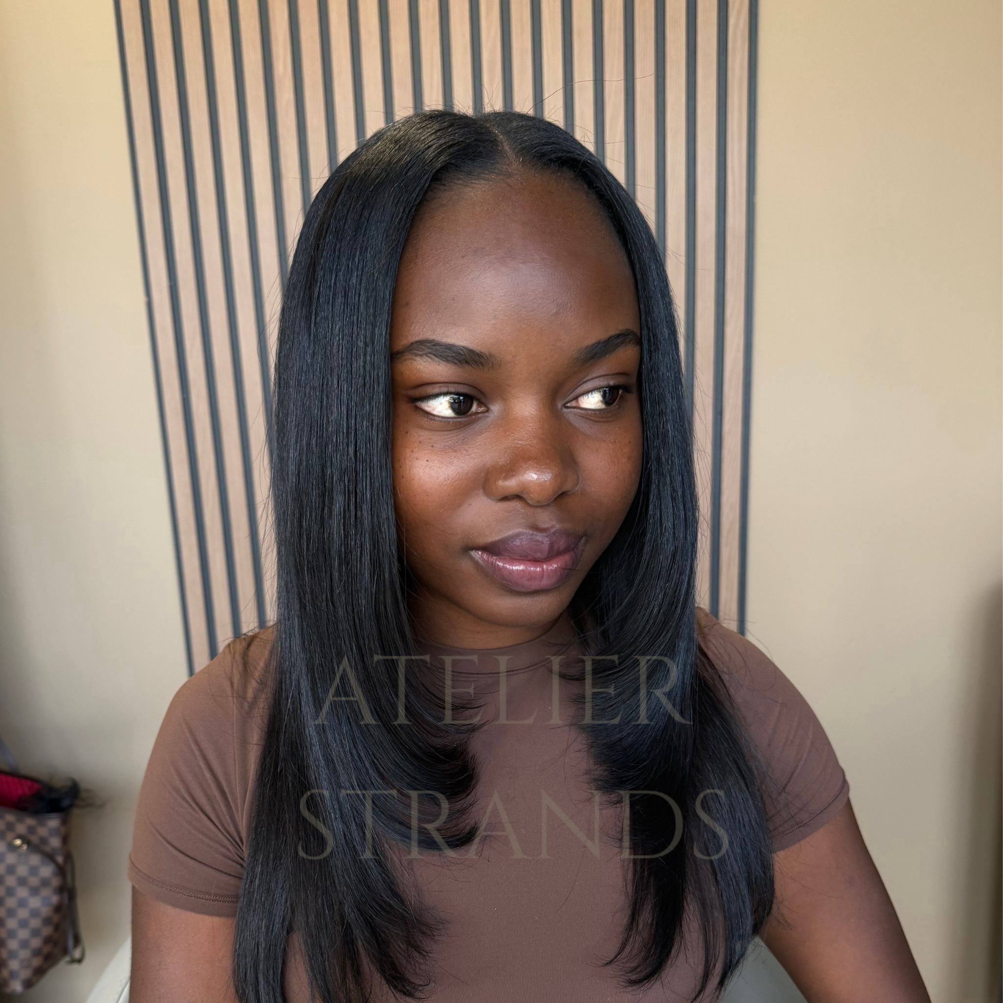 Customer wearing The Loft raw Cambodian wavy hair bundles Atelier Strands