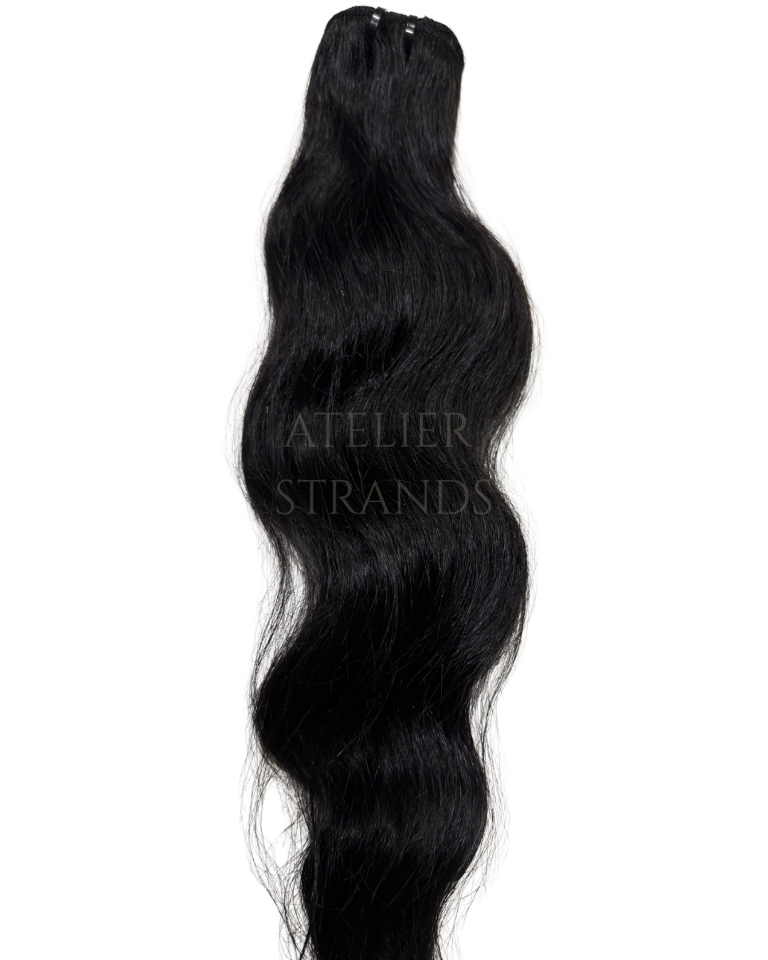 Cambodian natural wave hair extensions by Atelier Strands, full-bodied with refined textures.